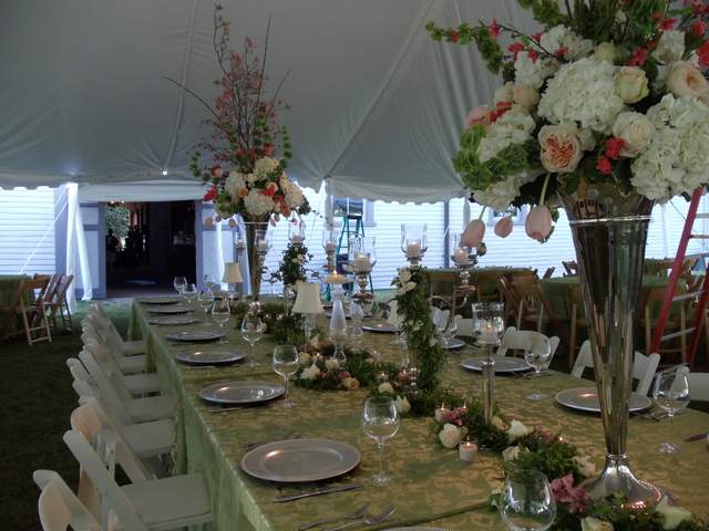 Tall silver vases and candles for wedding centerpiece